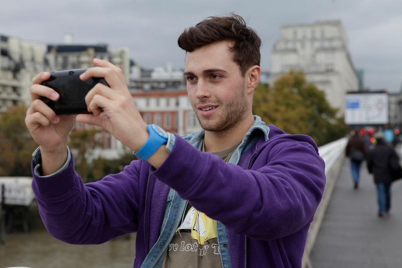 Illustration for article titled Attractive Young Men Smiling at the PlayStation Vita